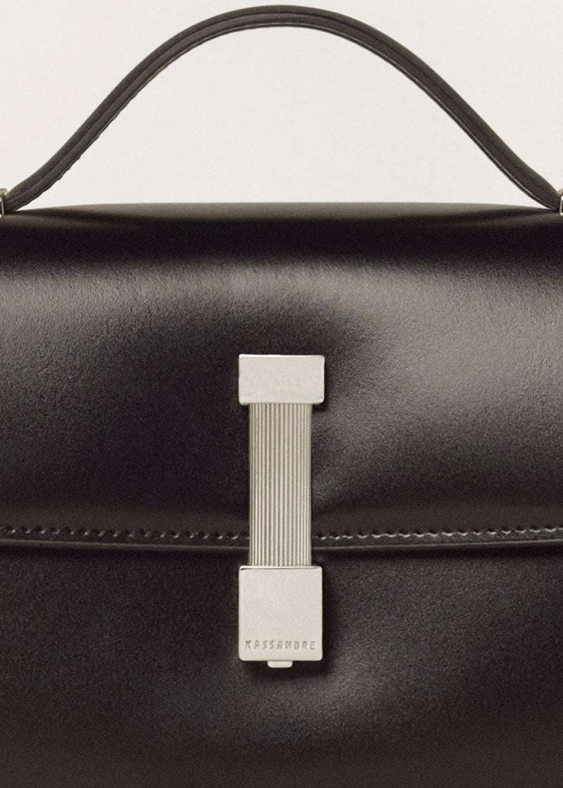 Kassandre Colonne clutch in black cow leather with silver hardware, rigorous lines, detail view