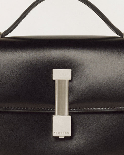 Kassandre Colonne clutch in black cow leather with silver hardware, rigorous lines, detail view