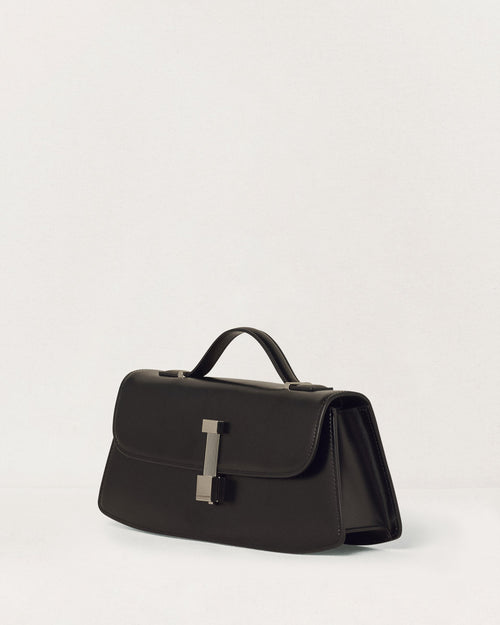 Kassandre Colonne clutch in black cow leather with silver hardware, rigorous lines, three quarter view
