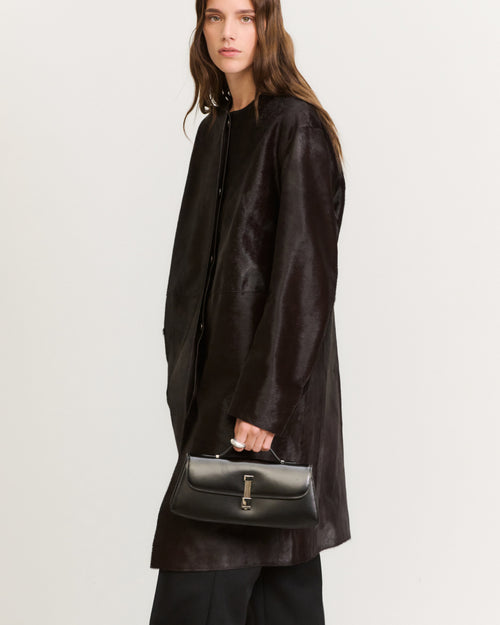 Kassandre Colonne clutch in black cow leather with silver hardware, rigorous lines, worn view