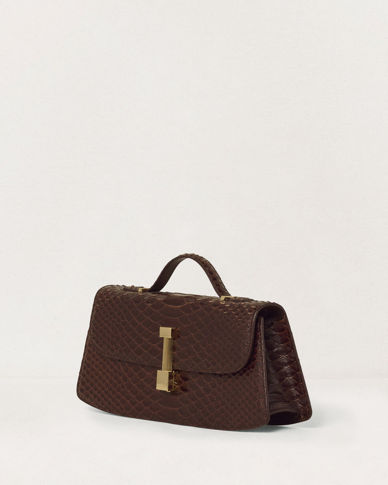 Kassandre Colonne clutch in brown python-effect leather with gold hardware, three quarter view