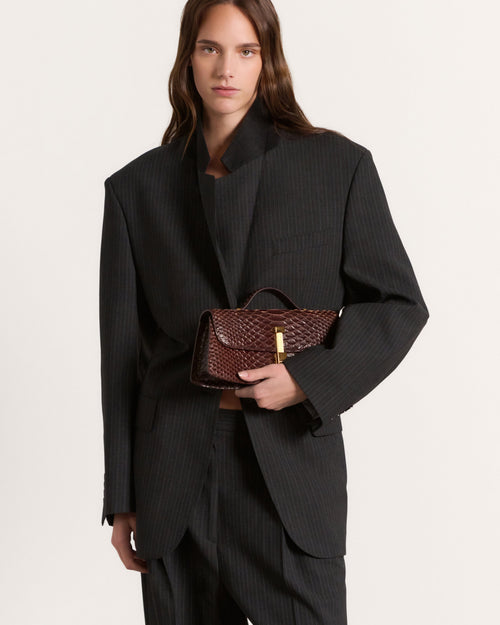 Kassandre Colonne clutch in brown python-effect leather with gold hardware, front view
