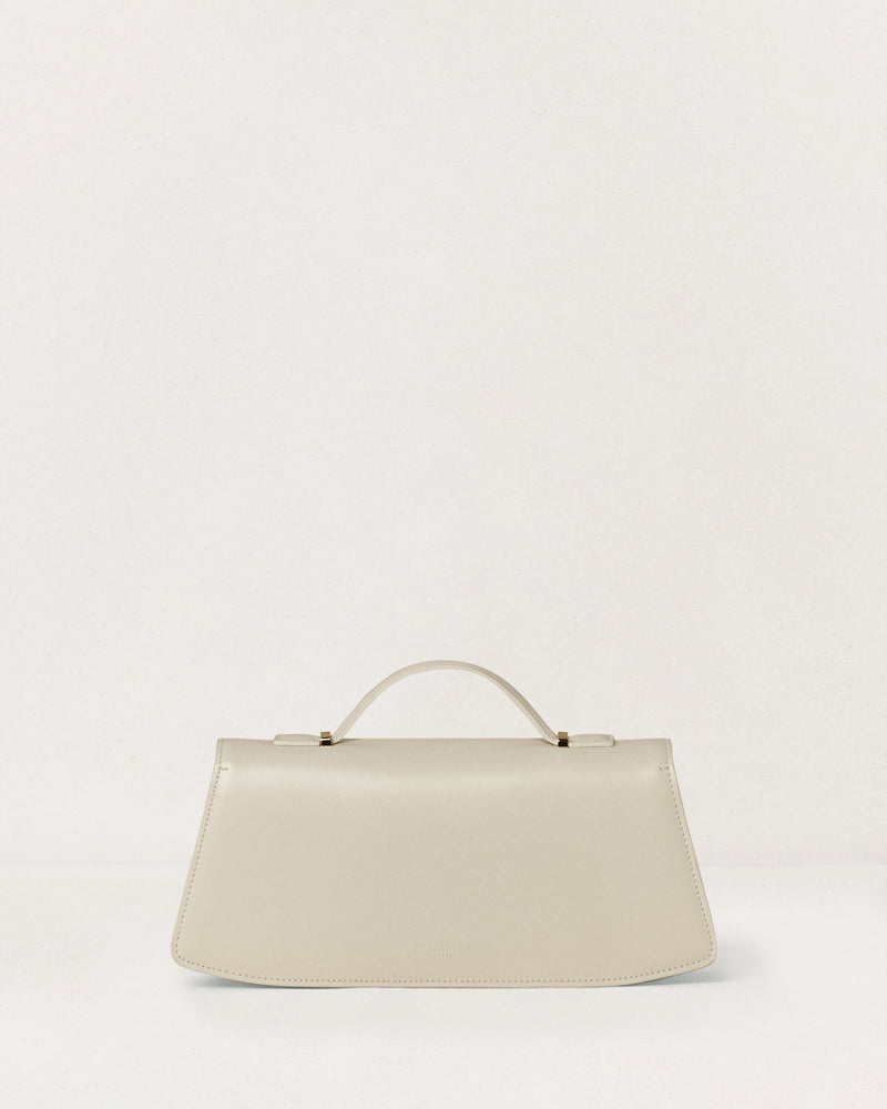 Kassandre Colonne clutch in off-white cow leather with gold hardware, rigorous lines, back view