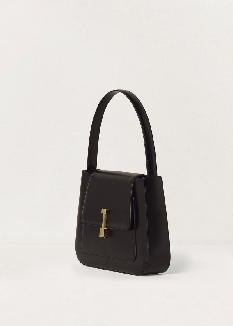 Kassandre Colonne hobo bag in black cow leather with gold hardware, column volume, three quarter view