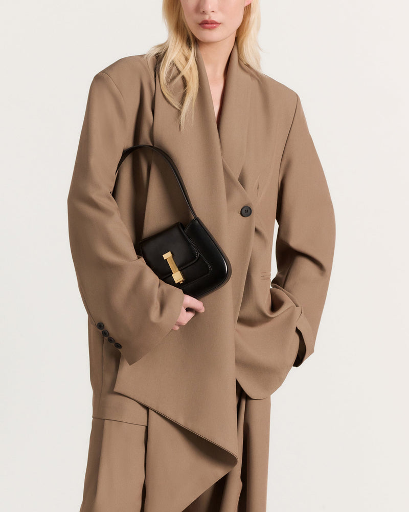 Kassandre Colonne mini hobo bag in black cow leather, column-like volume, worn view