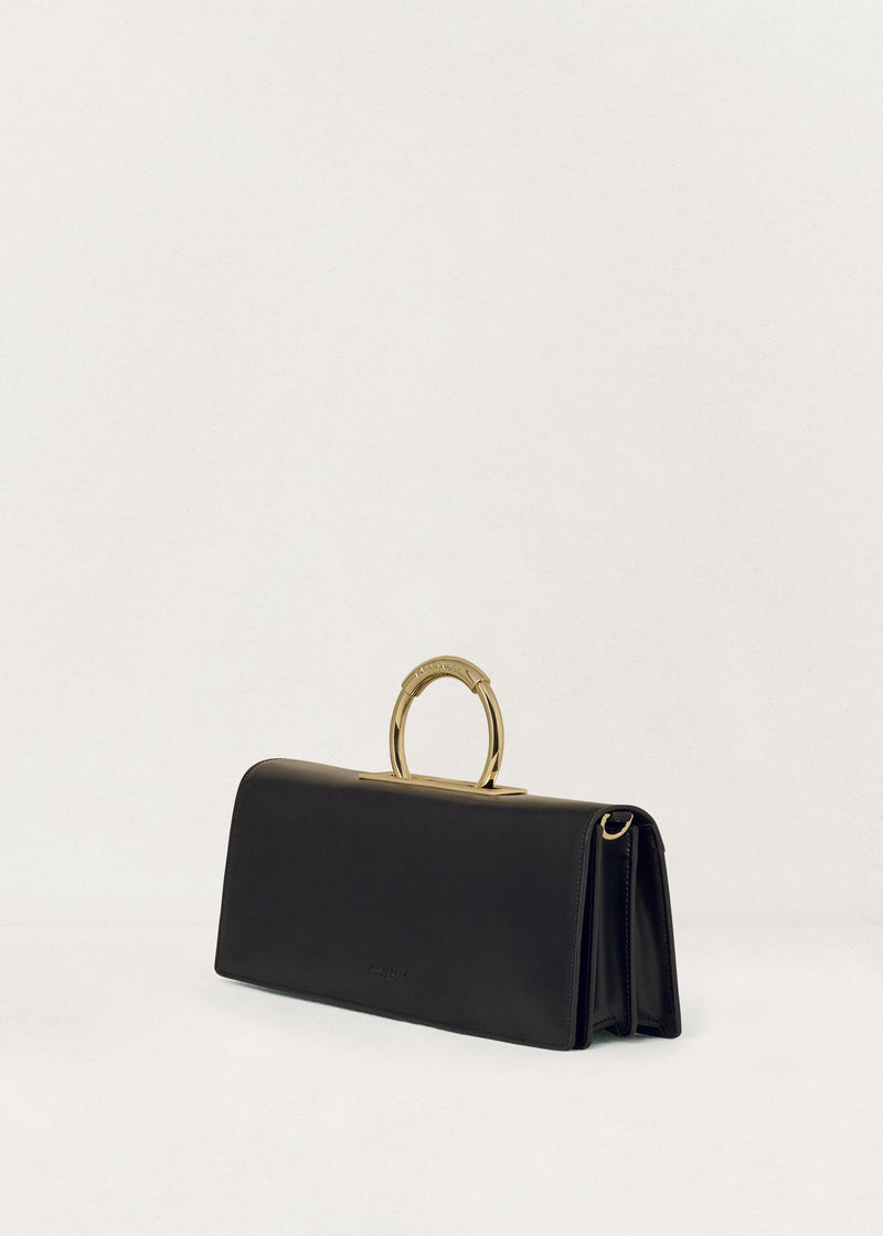 Kassandre Deva clutch in black cow leather with gold hardware, Art Deco geometry,removable strap , crossbody bag , three quarter view