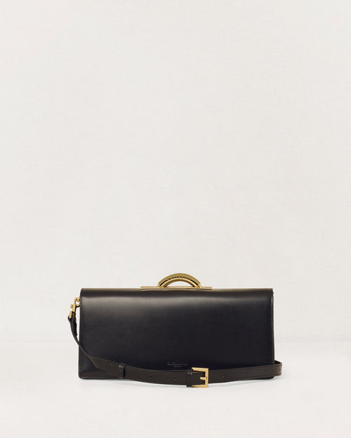 Kassandre Deva clutch in black cow leather with gold hardware, Art Deco geometry,removable strap , crossbody bag , front view