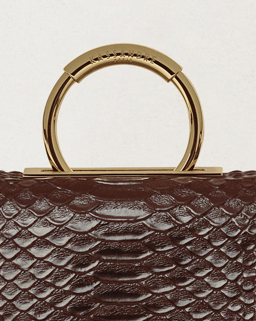 Kassandre Deva clutch in brown python-effect leather, sculptural Art Deco geometry, removable strap , crossbody bag ,detail view