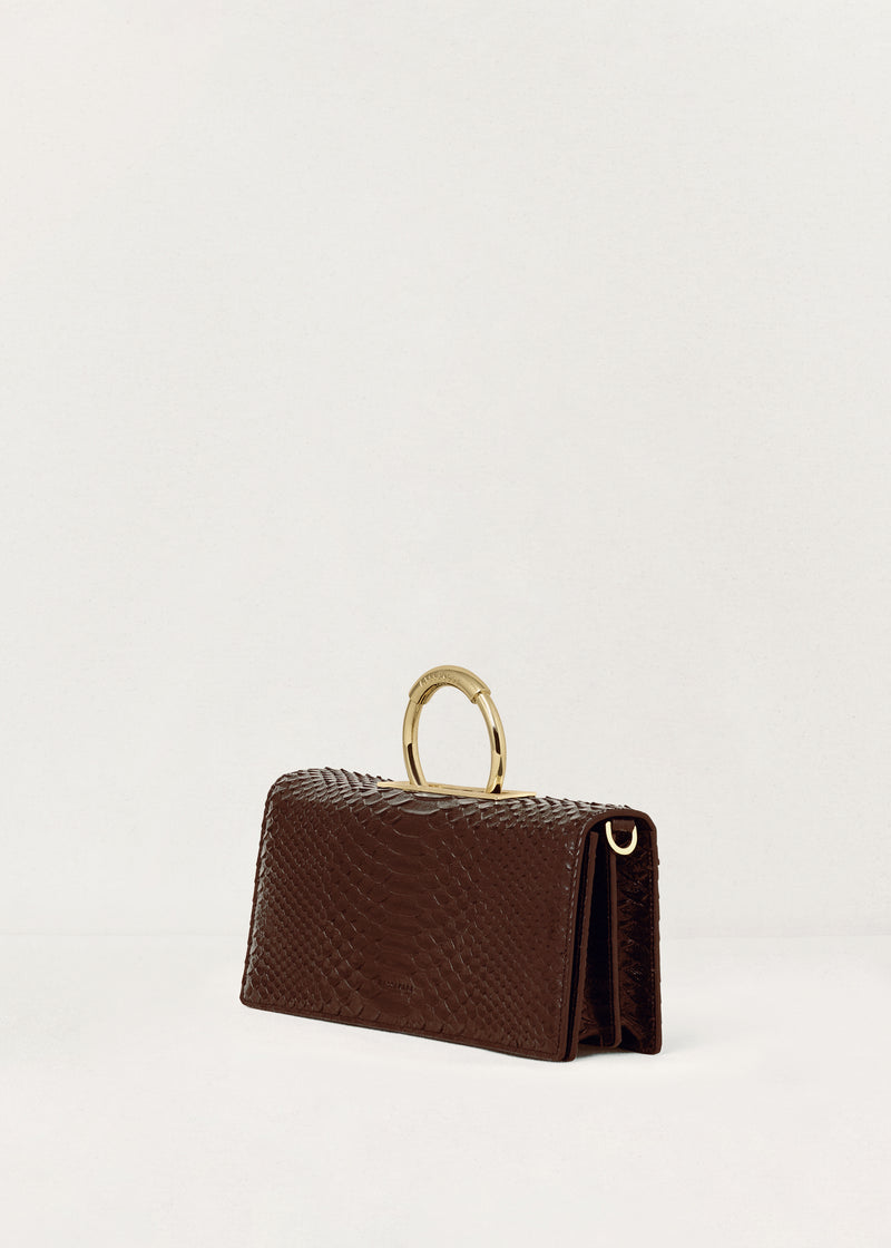 Kassandre Deva clutch in brown python-effect leather, sculptural Art Deco geometry, removable strap , crossbody bag ,three quarter view