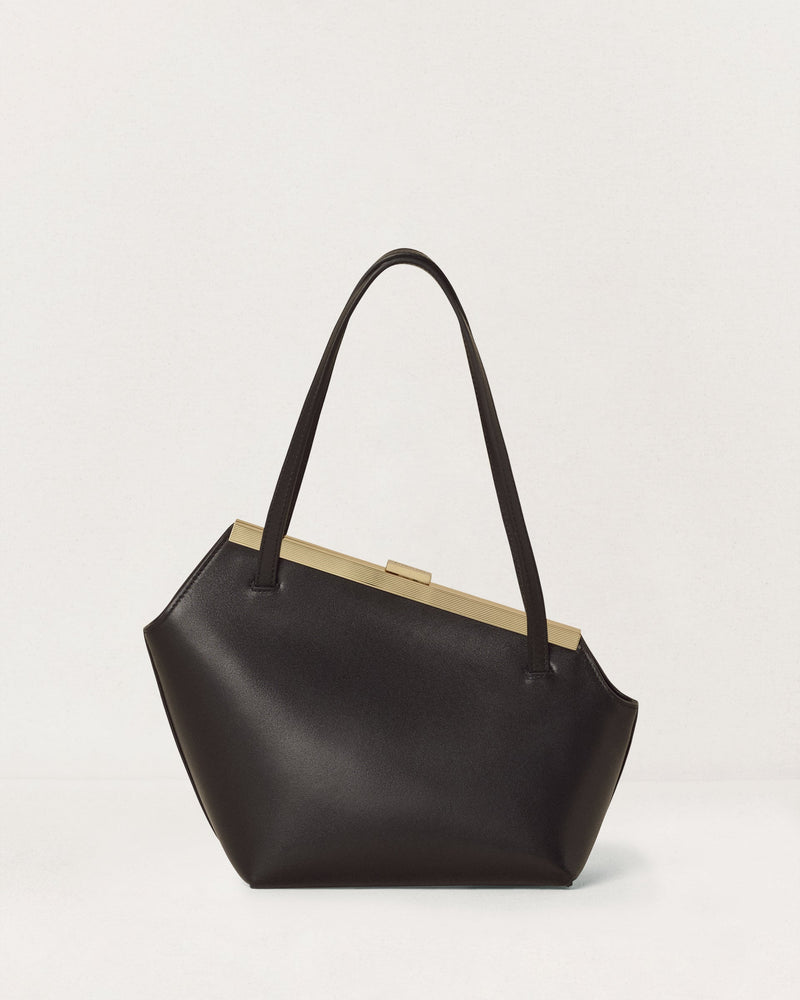 Kassandre Eileen asymmetric shoulder bag in black cow leather, architectural line, gold frame, back view