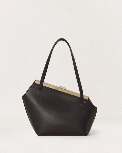 Kassandre Eileen asymmetric shoulder bag in black cow leather, architectural line, gold frame, back view