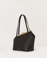 Kassandre Eileen asymmetric shoulder bag in black cow leather, architectural line, gold frame,three quarter view