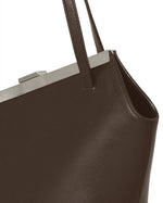 Kassandre Eileen asymmetric shoulder bag in brown cow leather, silver frame, graphic geometry, detail view