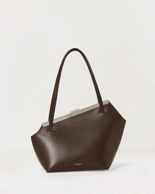 Kassandre Eileen asymmetric shoulder bag in brown cow leather, silver frame, graphic geometry, front view