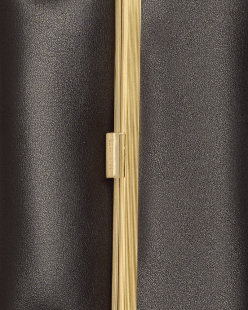Kassandre Eileen clutch in black cow leather with gold striped metal gold frame and engraved clasp