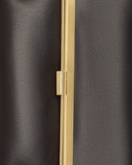 Kassandre Eileen clutch in black cow leather with gold striped metal gold frame and engraved clasp