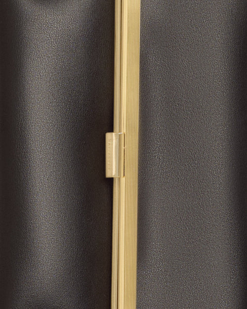 Kassandre Eileen clutch in black cow leather with gold striped metal gold frame and engraved clasp