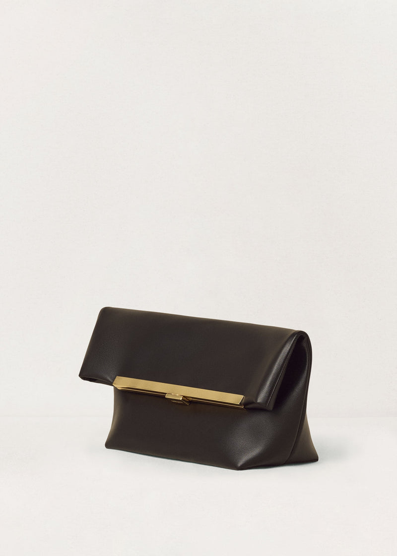 Kassandre Eileen clutch in black cow leather with gold striped metal gold frame and engraved clasp three quarter view