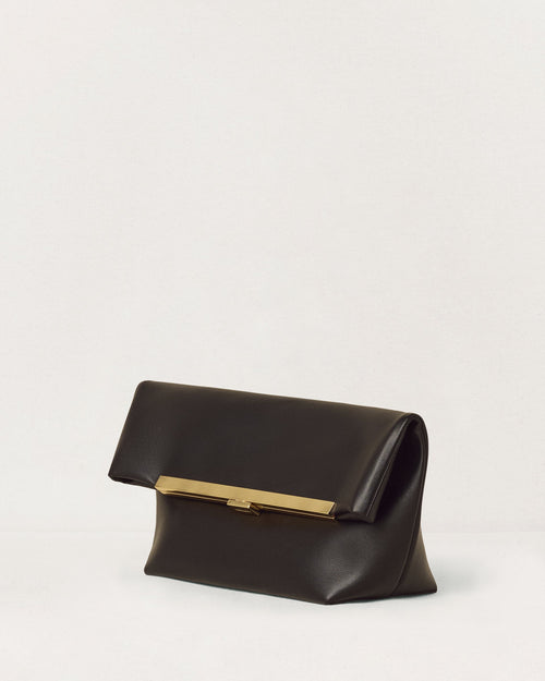 Kassandre Eileen clutch in black cow leather with gold striped metal gold frame and engraved clasp three quarter view