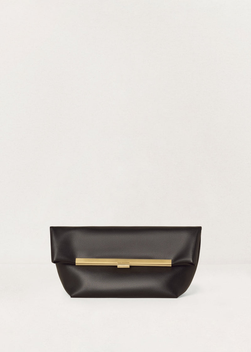 Kassandre Eileen clutch in black cow leather with gold striped metal frame and engraved clasp front view