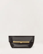 Kassandre Eileen clutch in black cow leather with gold striped metal frame and engraved clasp front view