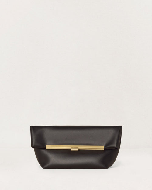 Kassandre Eileen clutch in black cow leather with gold striped metal frame and engraved clasp front view