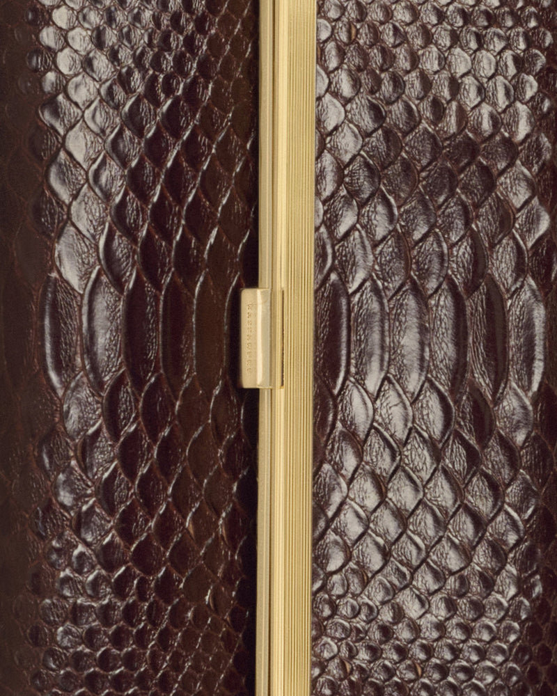Kassandre Eileen clutch in brown python-effect leather with striped metal frame, detail view