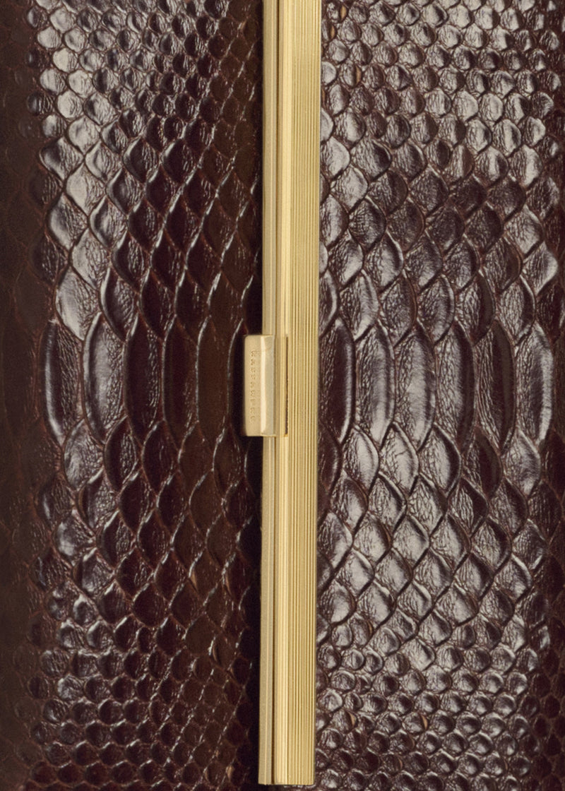 Kassandre Eileen clutch in brown python-effect leather with striped metal frame, detail view