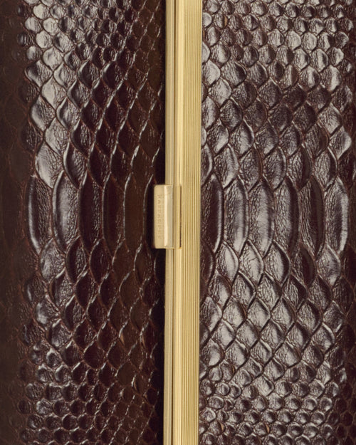 Kassandre Eileen clutch in brown python-effect leather with striped metal frame, detail view