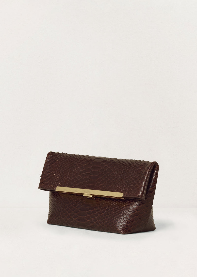 Kassandre Eileen clutch in brown python-effect leather with striped metal frame, three quarter view