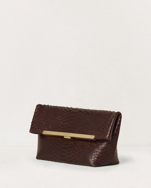 Kassandre Eileen clutch in brown python-effect leather with striped metal frame, three quarter view