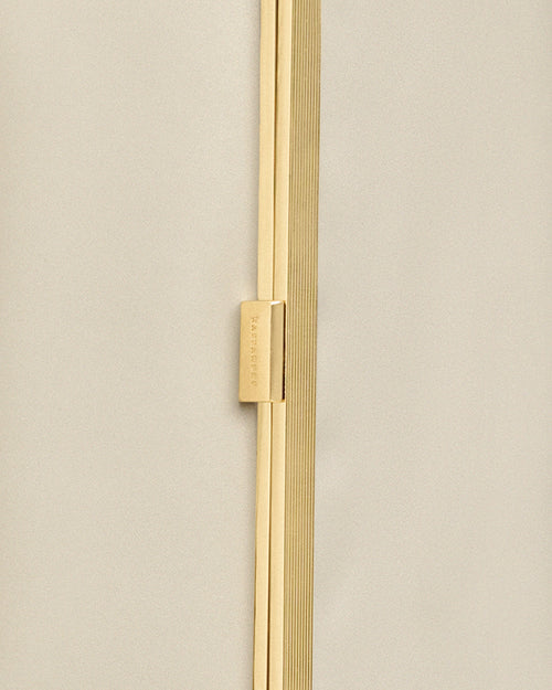 Kassandre Eileen clutch in off-white cow leather with gold metal frame, Art Deco lines , detail view
