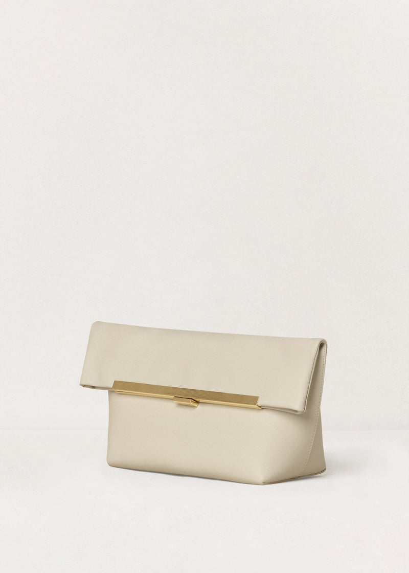 Kassandre Eileen clutch in off-white cow leather with gold metal frame, Art Deco lines , three quarter view