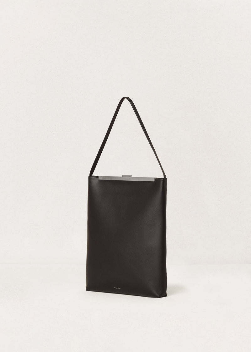 Kassandre Eileen computer bag in black cow leather with silver striped metal frame,three quarter view