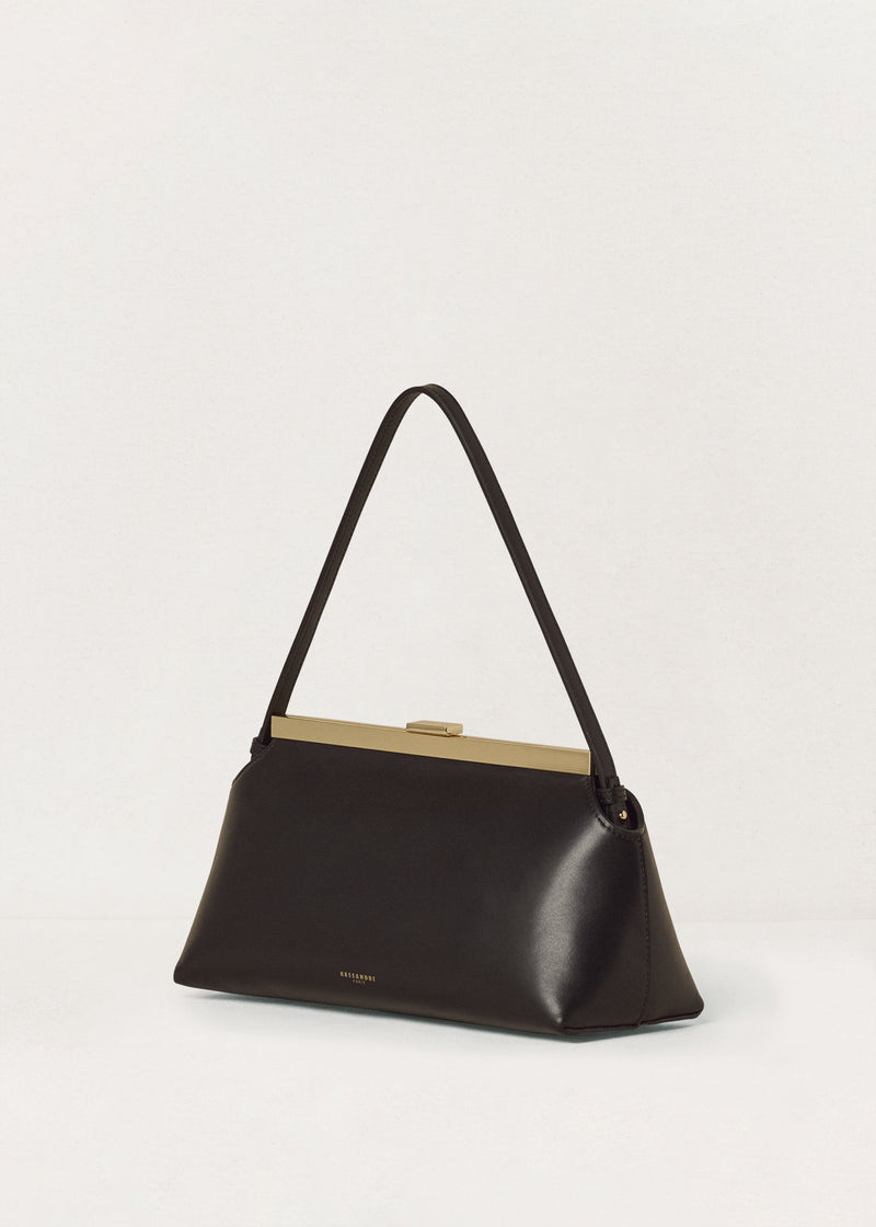 Kassandre Eileen shoulder bag in black smooth cow leather with striped metal frame, three quarter view