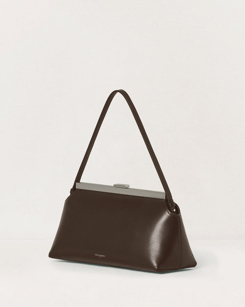 Kassandre Eileen shoulder bag in brown smooth cow leather with striped metal frame, three quarter view