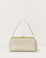 Kassandre Eileen shoulder bag in off-white cow leather with gold striped metal frame, front view